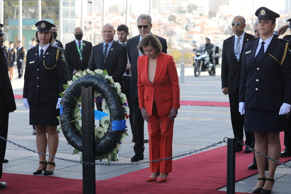 U.S. House Speaker Nancy Pelosi, center, lays a wreath during an official welcome ceremony at the Knesset, the Israeli Parliament in Jerusalem Wednesday, Feb. 16, 2022. (Abir Sultan/Pool Photo via AP)