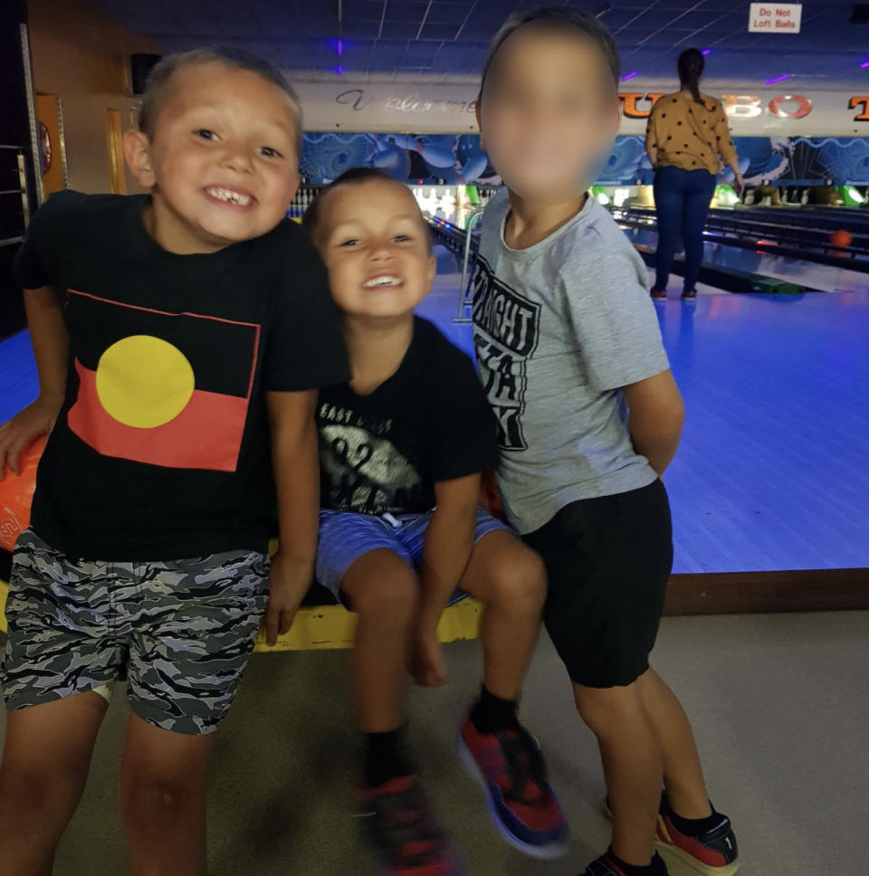 Mark, 9, with Shane and Sheldon at a bowling alley.