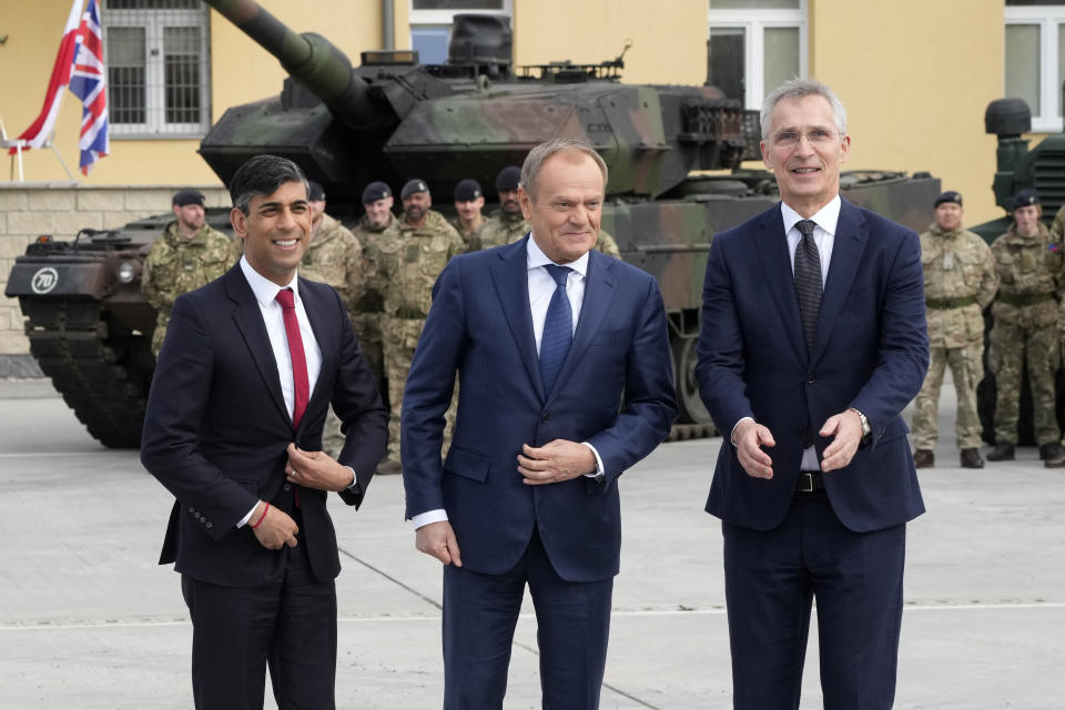 Britain's Prime Minister Rishi Sunak, left, Poland's Prime Minister Donald Tusk, center, and NATO Secretary General Jens Stoltenberg, right, visit the Armourd Brigade barracks in Warsaw, Poland, Tuesday, April 23, 2024. (AP Photo/Czarek Sokolowski)