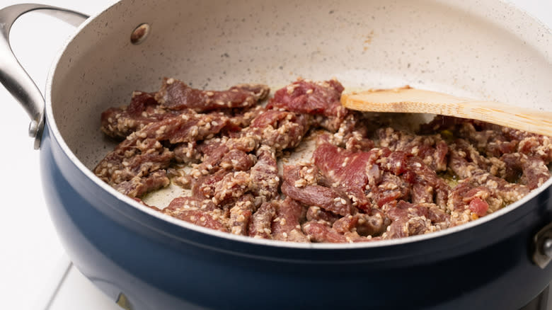 Sesame beef cooking in pan
