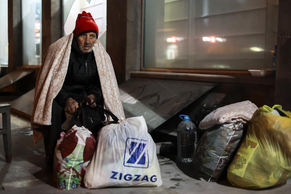 An ethnic Armenian man from Nagorno-Karabakh sits near a tent camp after arriving to Armenia's Goris in Syunik region, Armenia, late Friday, Sept. 29, 2023. Armenian officials say that by Friday evening over 97,700 people had left Nagorno-Karabakh. The region's population was around 120,000 before the exodus began. (AP Photo/Vasily Krestyaninov)