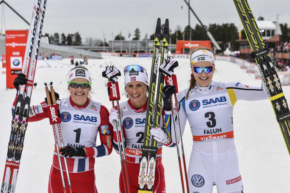 Norway's Marit Bjoergen, middle, first place, and Stina Nilsson, right, of Sweden, third place with Norway's Ingvild Flugstad Oestberg, left, second place, celebrate after the final of the FIS Cross-Country World Cup Women's 1,2 km Sprint Classic in Falun, Sweden, Friday, March 14, 2014. (AP Photo/TT, Anders Wiklund) SWEDEN OUT