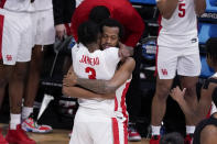 Houston guard DeJon Jarreau (3) hugs Justin Gorham (4) during the second half of an Elite 8 game against Oregon State in the NCAA men's college basketball tournament at Lucas Oil Stadium, Monday, March 29, 2021, in Indianapolis. Houston won 67-61. (AP Photo/Michael Conroy)