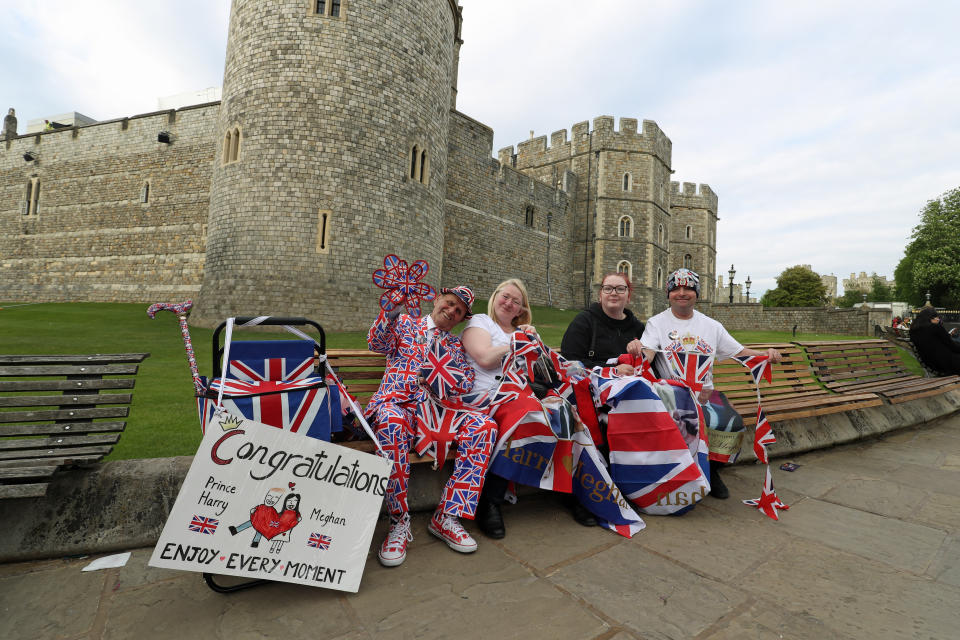 Royal fans (left to right) Terry Hutt, Maria Scott, Amy Thompson and John Loughrey sit on benches outside Windsor Castle in Windsor ahead of the royal wedding this weekend (PA)