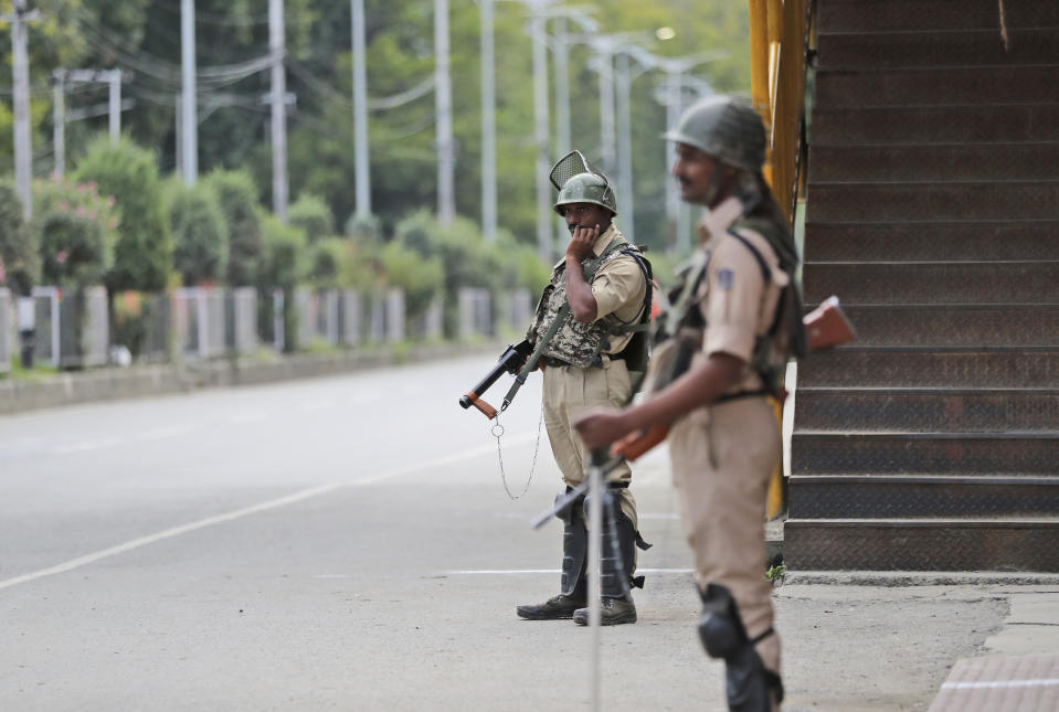 Indian paramilitary soldiers stand guard during a security lockdown in Srinagar, Indian controlled Kashmir, Monday, Aug. 12, 2019. Troops in India-administered Kashmir allowed some Muslims to walk to local mosques alone or in pairs to pray for the Eid al-Adha festival on Monday during an unprecedented security lockdown that still forced most people in the disputed region to stay indoors on the Islamic holy day. (AP Photo/Mukhtar Khan)