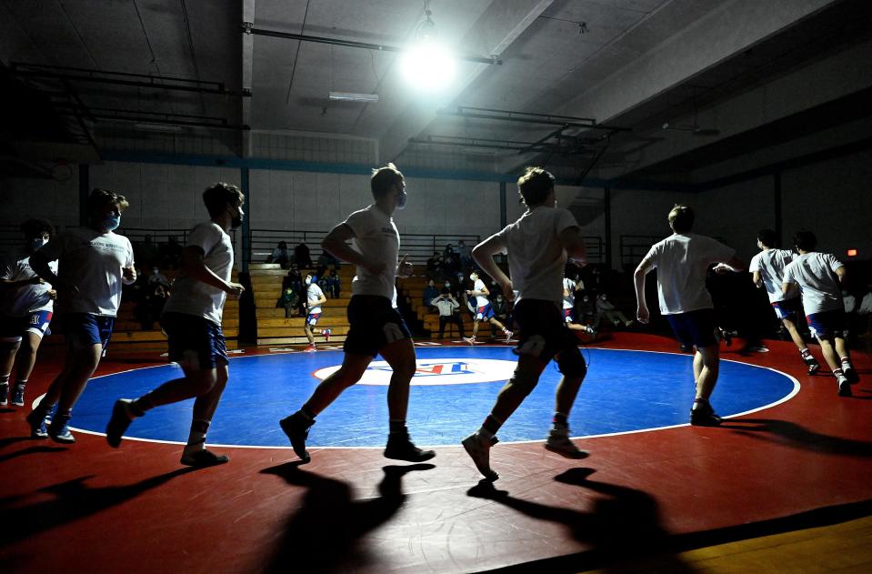 The Ashland wrestling team enters the gym for a match against Wayland at Ashland Middle School, Jan. 13, 2021.  