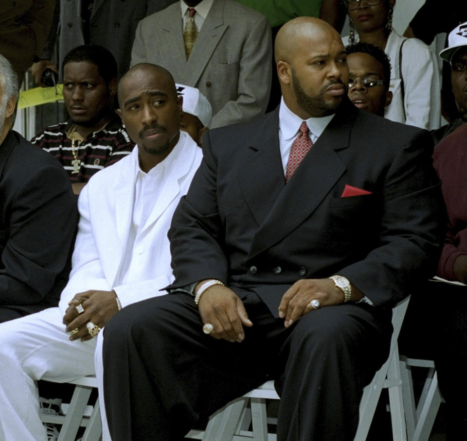 FILE - Rapper Tupac Shakur, left, and Death Row Records Chairman Marion "Suge" Knight, attend a voter registration event in South Central Los Angeles, August 15, 1996. Shakur's shooting in a New York recording studio in the mid-1990s sparked hip-hop's biggest rivalry and led to the shocking deaths of two of the genre's greatest stars. Shakur and Notorious B.I.G. were gunned down in drive-by shootings only six months apart. Nearly three decades later, the recent arrest of longtime suspect Duane “Keffe D” Davis has ignited another wave of intrigue in their unsolved murders. (AP Photo/Frank Wiese, File)