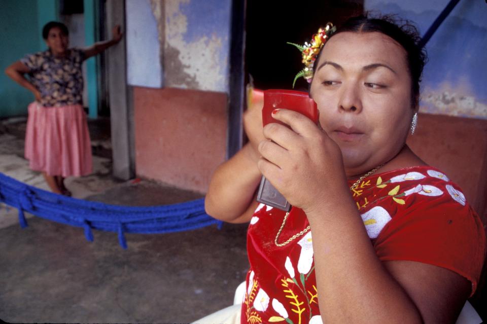 JUCHITAN, MEXICO- OCTOBER 1: Fidela Gomez Castillo, 43 years old, and Mistica Sonenez Gomez, 25 years old laugh in Juchitan, Mexico, October 1, 2002. In the sleepy southern Mexican fishing town of Juchitan of roughly 85,000 people and its ancient Zapotekan culture, no one dares wonders about men in women's clothing. In Juchitan, giving birth to a girl is celebrated whereas giving birth to a boy produces condolences. In this matriarchal society, female figures are strong and revered in the community and so many Zapotekan mothers choose one or more sons at a very young age, sometimes at 3 or 4 years old, to be raised as girls. The mothers don't call their chosen sons transvestites. They call them, in the Zapotekan language, "Musches", which means neither men nor women but something better. (Photo by Shaul Schwarz/ Getty Images)