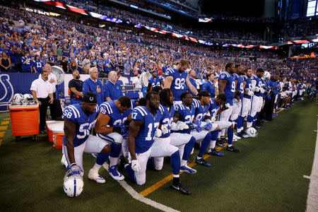 FILE PHOTO: Indianapolis Colts players kneel during the playing of the National Anthem before the game against the Cleveland Browns at Lucas Oil Stadium in Indianapolis, IN, U.S., September 24, 2017. Mandatory Credit: Brian Spurlock-USA TODAY Sports/File Photo