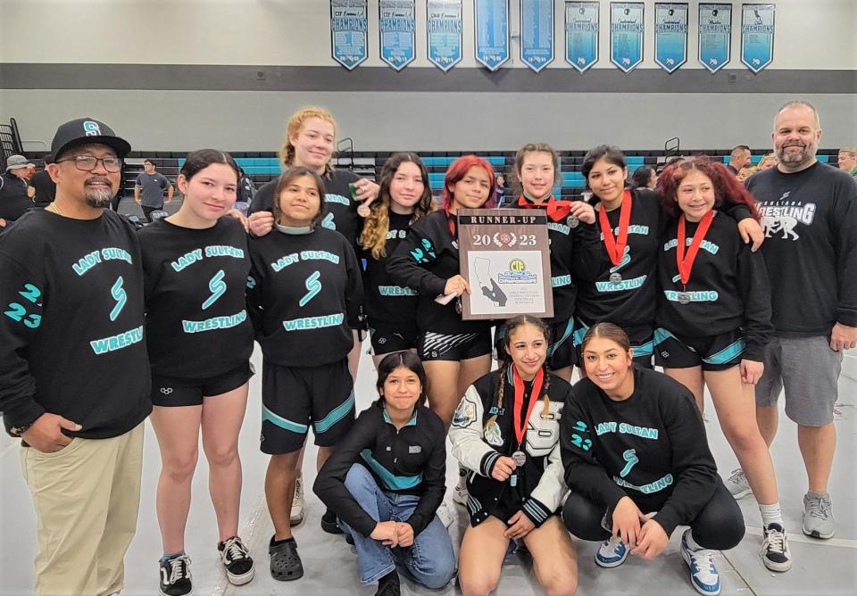 The Sultana wrestling team poses for a photo after claiming second place with 152 points at the CIF-Southern Section Central Division girls wrestling tournament, held at Canyon Springs High School, on Saturday.