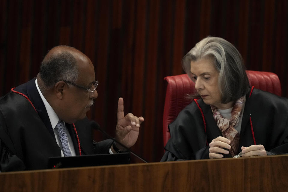 Corregidor and Minister Rapporteur of the Supreme Electoral Court, Minister Benedito Goncalves, left, talks with Minister Carmen Lucia at the start of the trial of former President Jair Bolsonaro at the Supreme Court in Brasilia, Brazil, Thursday, June 22, 2023. Judges are evaluating the case which claims the leader abused his power by using government communication channels to promote his campaign and cast unfounded doubts on the country’s electronic voting system. (AP Photo/Eraldo Peres)