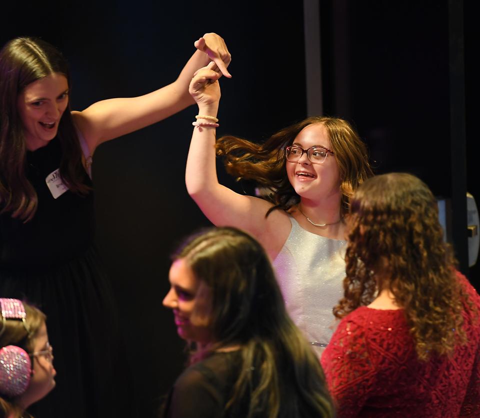 First Baptist Spartanburg joined with the Tim Tebow Foundation to host its annual 'Night to Shine Prom' event for adults with special needs. The event was held at the 'Hangar' in downtown Spartanburg on Feb. 9. Ashton Scruggs, left, spins her buddy, Avery West, center, on the dance floor.