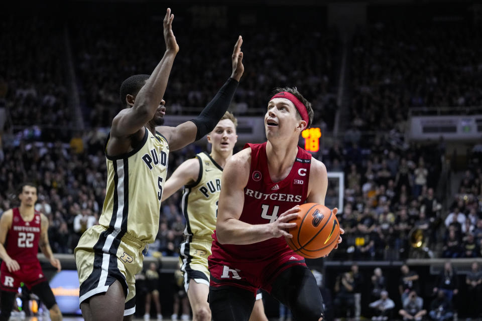 Rutgers guard Paul Mulcahy (4) looks to shoots over Purdue guard Brandon Newman (5) during the first half of an NCAA college basketball game in West Lafayette, Ind., Monday, Jan. 2, 2023. (AP Photo/Michael Conroy)