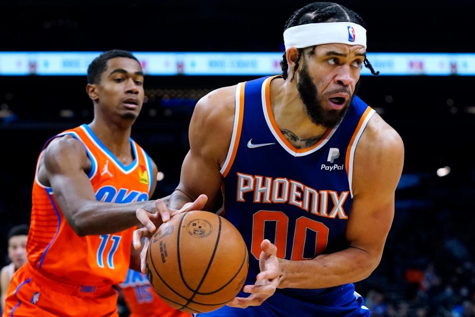 Phoenix Suns center JaVale McGee (00) grabs a rebound in front of Oklahoma City Thunder guard Theo Maledon (11) during the second half of an NBA basketball game Wednesday, Dec. 29, 2021, in Phoenix. The Suns won 115-97. (AP Photo/Ross D. Franklin)