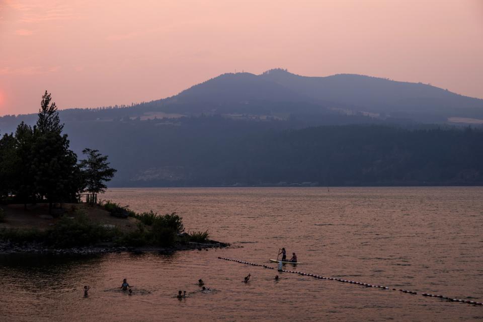 Kids swim at a waterfront park.