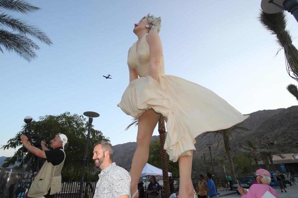 People gather for the unveiling of the "Forever Marilyn" statue in downtown Palm Springs on June 20, 2021.