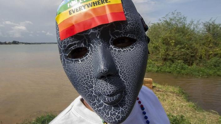 Person with mask and rainbow sticker