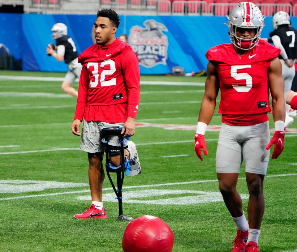 Dec 29, 2022; Atlanta, GA, USA; Ohio State Buckeyes running back TreVeyon Henderson (32) watches the running backs during a drill during team practice for the Peach Bowl at the Mercedes-Benz Stadium.