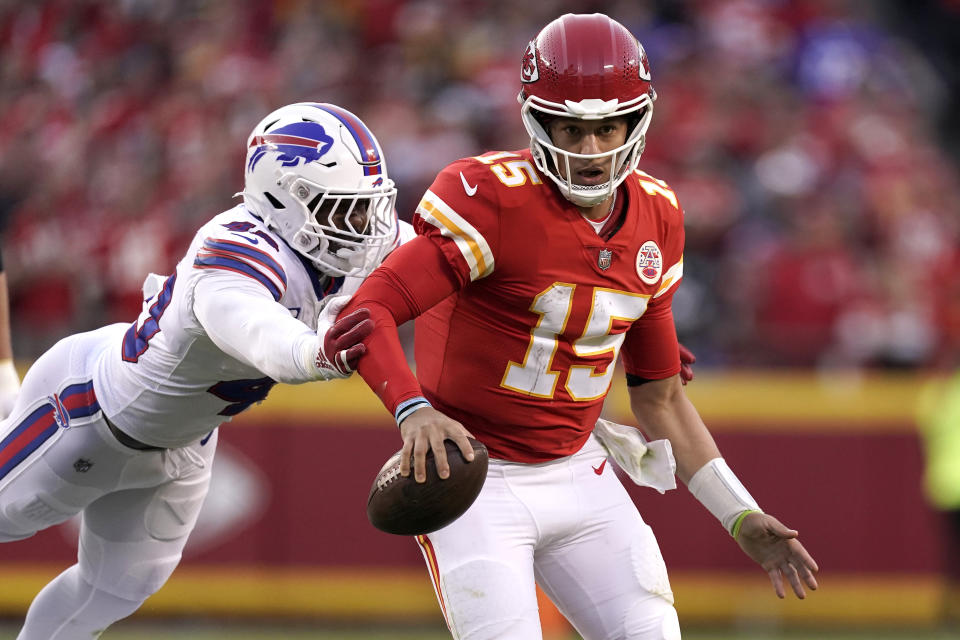 Kansas City Chiefs quarterback Patrick Mahomes (15) scrambles as Buffalo Bills linebacker Von Miller (40) defends during the second half of an NFL football game Sunday, Oct. 16, 2022, in Kansas City, Mo. (AP Photo/Charlie Riedel)