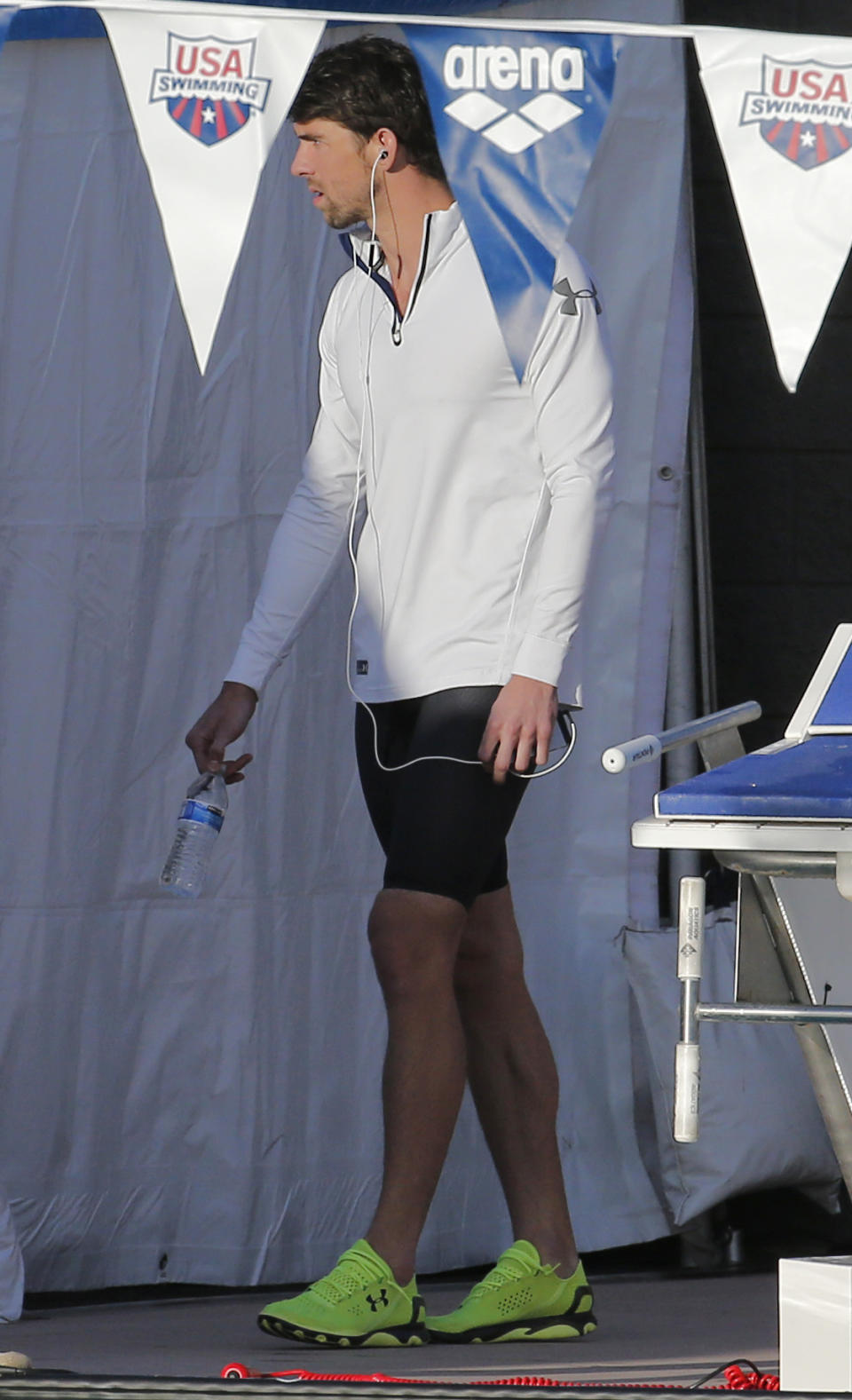 Michael Phelps arrives for the 100-meter butterfly final during the Arena Grand Prix, Thursday, April 24, 2014, in Mesa, Ariz. Phelps finished second in the final. (AP Photo/Matt York)