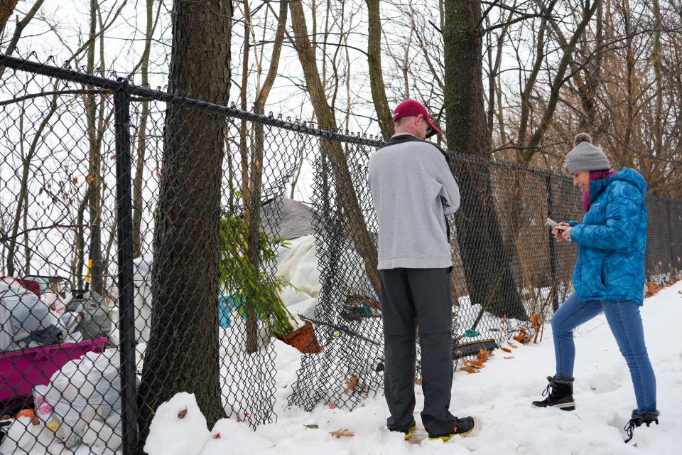 Amanda Murphy, right, reads out a survey to a man as part of the point in time (PIT) count of individuals facing homelessness on Thursday, Jan. 25, 2024, in Des Moines.