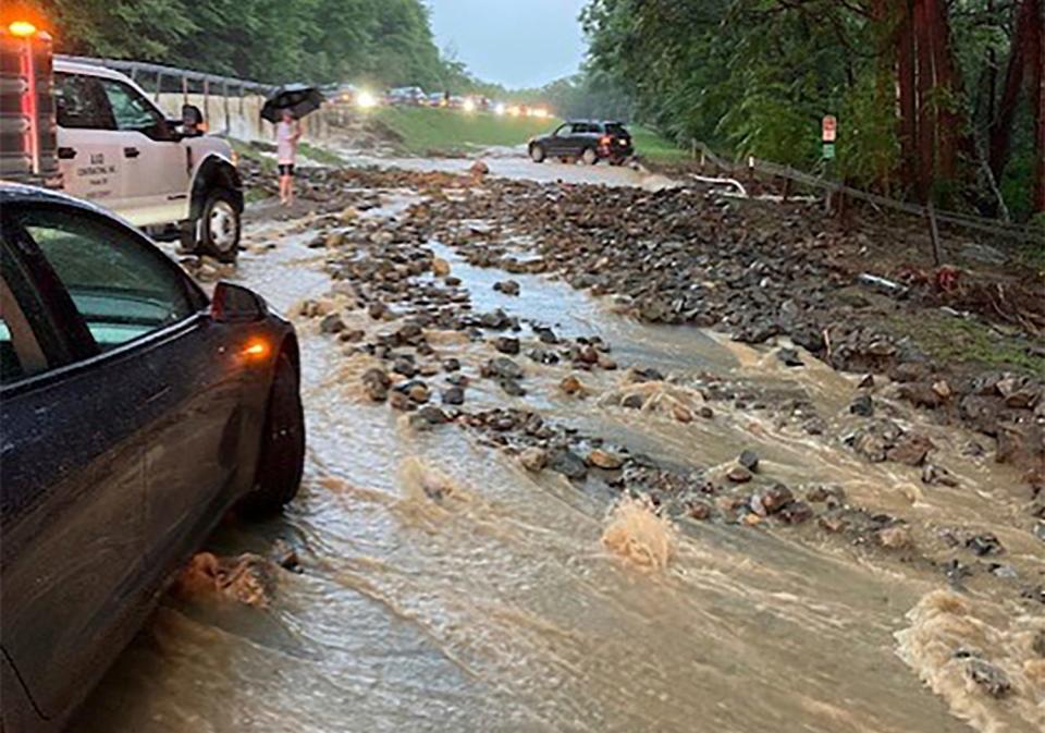 Vehicles come to a standstill near a washed-out and flooded portion of the Palisades Parkway just beyond the traffic circle off the Bear Mountain Bridge, Sunday, July 9, 2023, in Orange County, N.Y. Heavy rain spawned extreme flooding in New York’s Hudson Valley that killed at least one person, swamped roadways and forced road closures on Sunday night, as much of the rest of the Northeast U.S. geared up for a major storm.