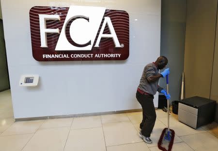 A maintenance worker cleans the entrance area of the headquarters of the new Financial Conduct Authority (FCA) in the Canary Wharf business district of London April 1, 2013. REUTERS/Chris Helgren