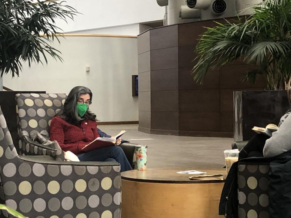 April Lidinsky, who helped to organize the event, reads during a recent The Reading Hour-South Bend gathering in the DoubleTree by Hilton's atrium in downtown South Bend.