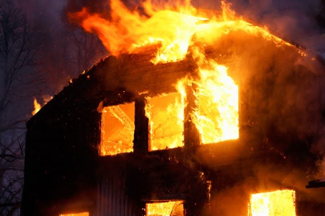 C55M81 Wooden house buring. burning; fire; disaster; insurance; flames; orange; yellow; house; wooden; fire; burns; arson