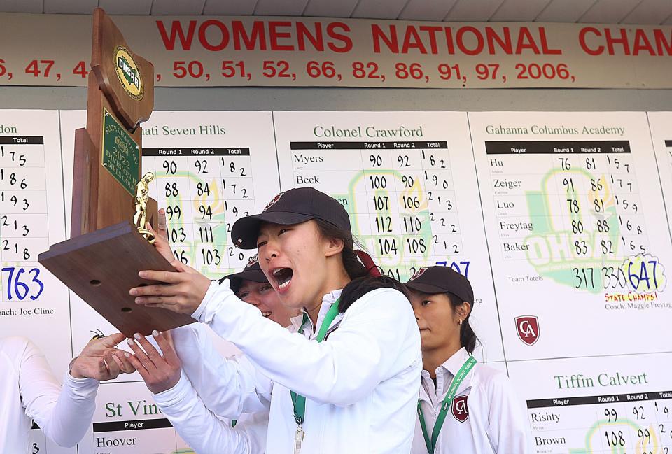 Columbus Academy's Angela Hu celebrates with the championship trophey after the Lady Vikings won the Girls Division II State Championships on Oct. 15 at the Ohio State Golf Club Gray Course.