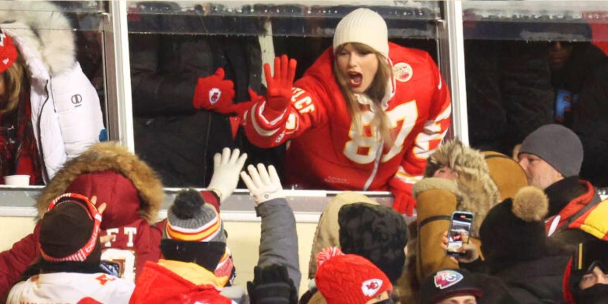 Taylor Swift high-fiving fans at NFL game