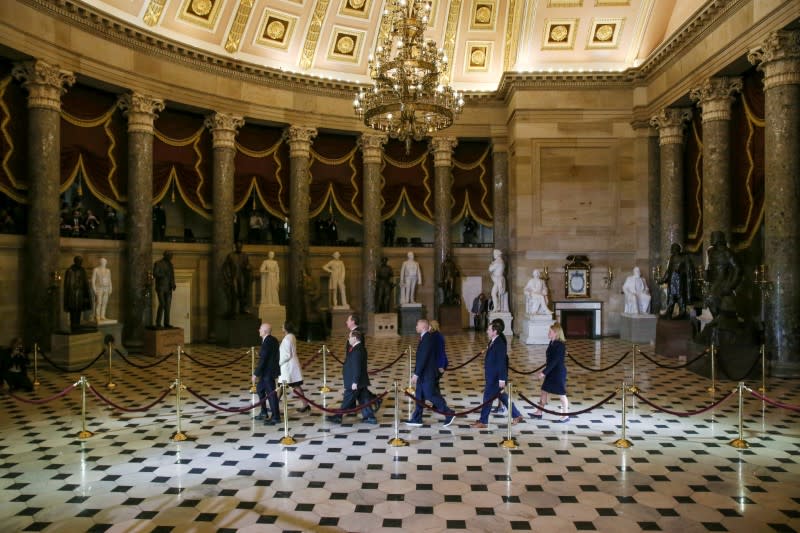 House Sergeant at Arms Irving and House Clerk Johnson carry impeachment articles during procession at the U.S. Capitol in Washington