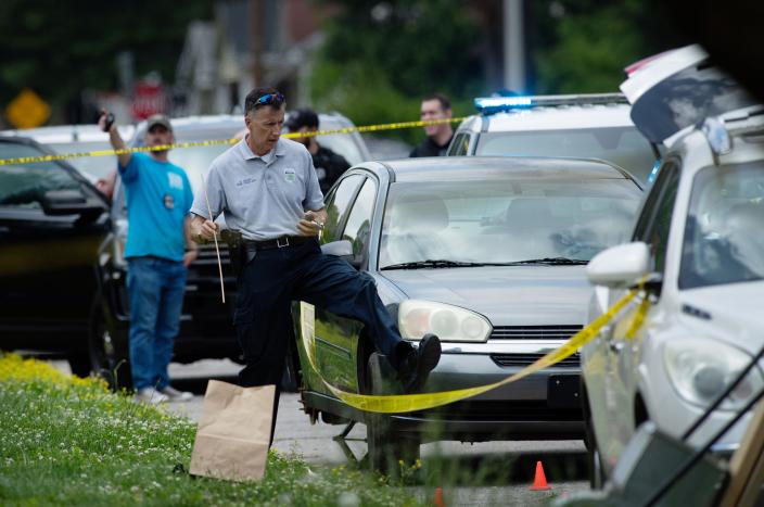 Evansville Police Department Crime Scene Unit Det. B. Gentry crosses the caution tape during an investigation of an officer involved shooting in the 1500 block of E. Indiana Street in Evansville Tuesday afternoon, May 9, 2023. Two EPD officers fired and shot a man when he allegedly reached for a firearm inside his parked vehicle. The man was taken to the hospital and was conscious. 