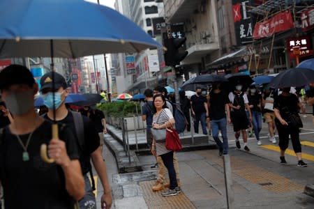 Anti-government demonstrators march in protest against the invocation of the emergency laws in Hong Kong