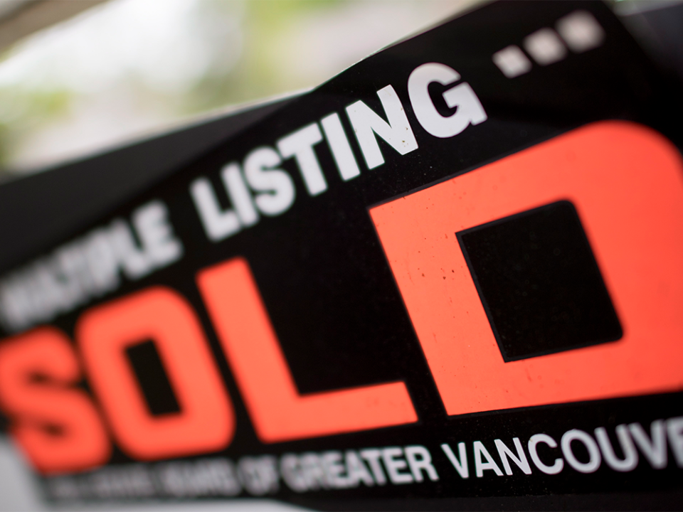  Sold sign in front of Vancouver home.