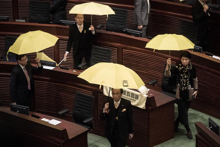 Pro-democracy lawmakers walk out in protest before the policy address of Hong Kong Chief Executive Leung Chun-ying in the legislative council in Hong Kong on January 14, 2015