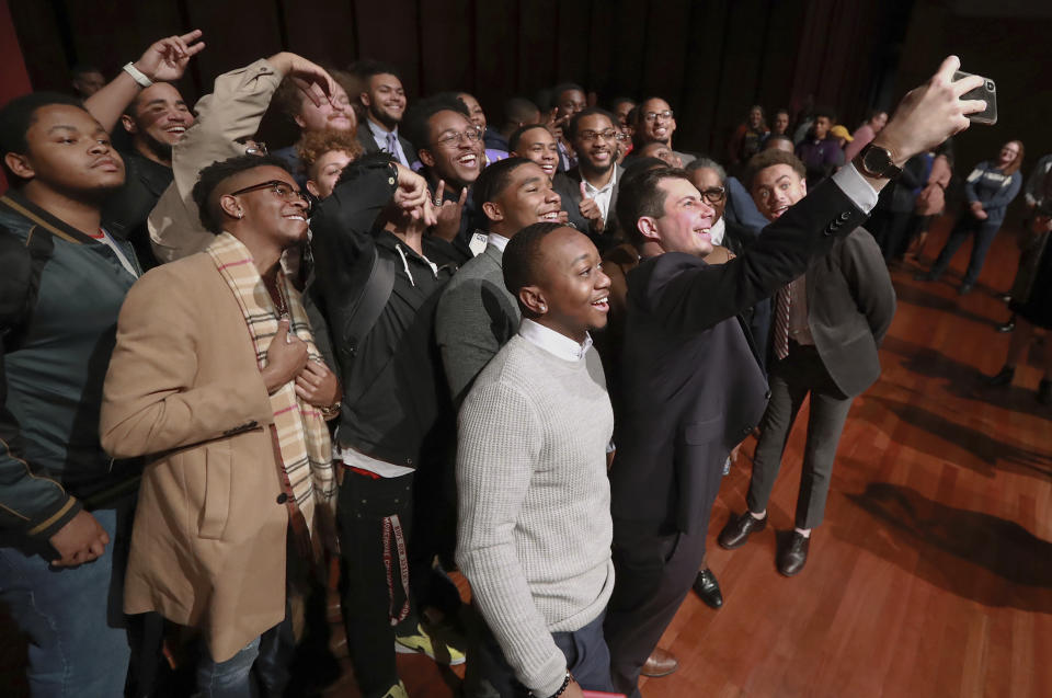 Presidential hopeful Pete Buttigieg, Mayor of South Bend, Ind., snaps a selfie with students after speaking at Morehouse College on Monday, Nov. 18, 2019, in Atlanta. (Curtis Compton/Atlanta Journal-Constitution via AP)
