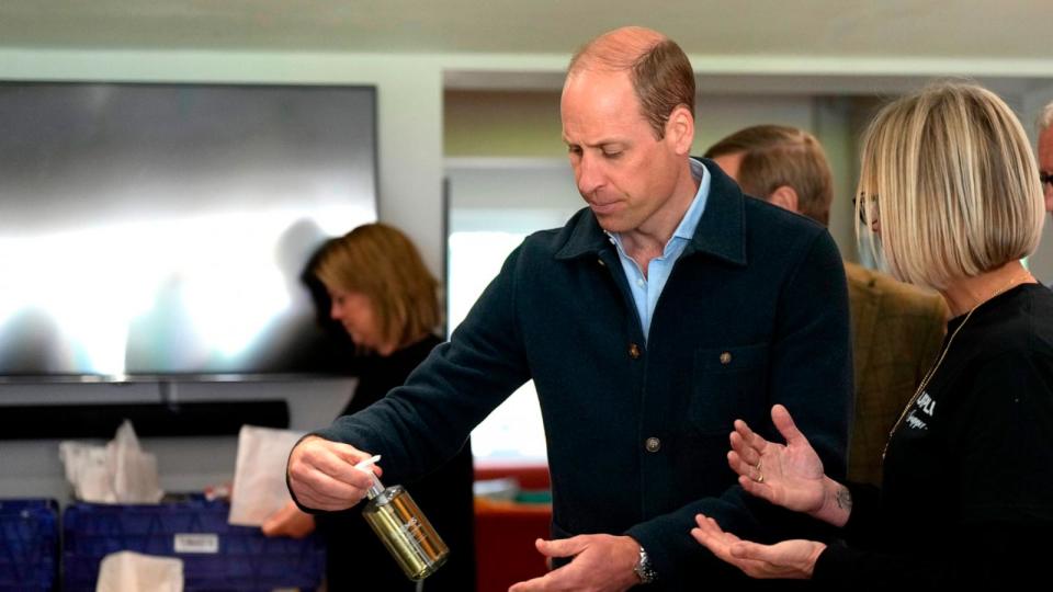 PHOTO: Prince William, Prince of Wales  is shown items by Claire Hopkins, Operations Director, right, during a visit to Surplus to Supper, in Sunbury-on-Thames on April 18, 2024 in Surrey, England. (Alastair Grant-WPA Pool/Getty Images)