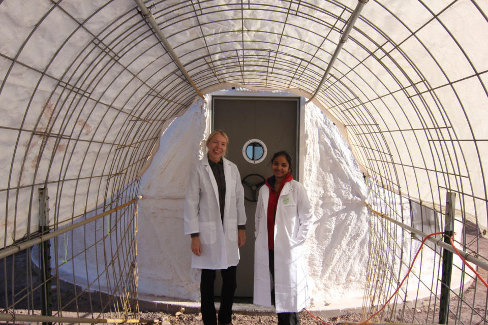 Anastasiya and Anushree by the lab door. <cite>The Mars Society</cite>