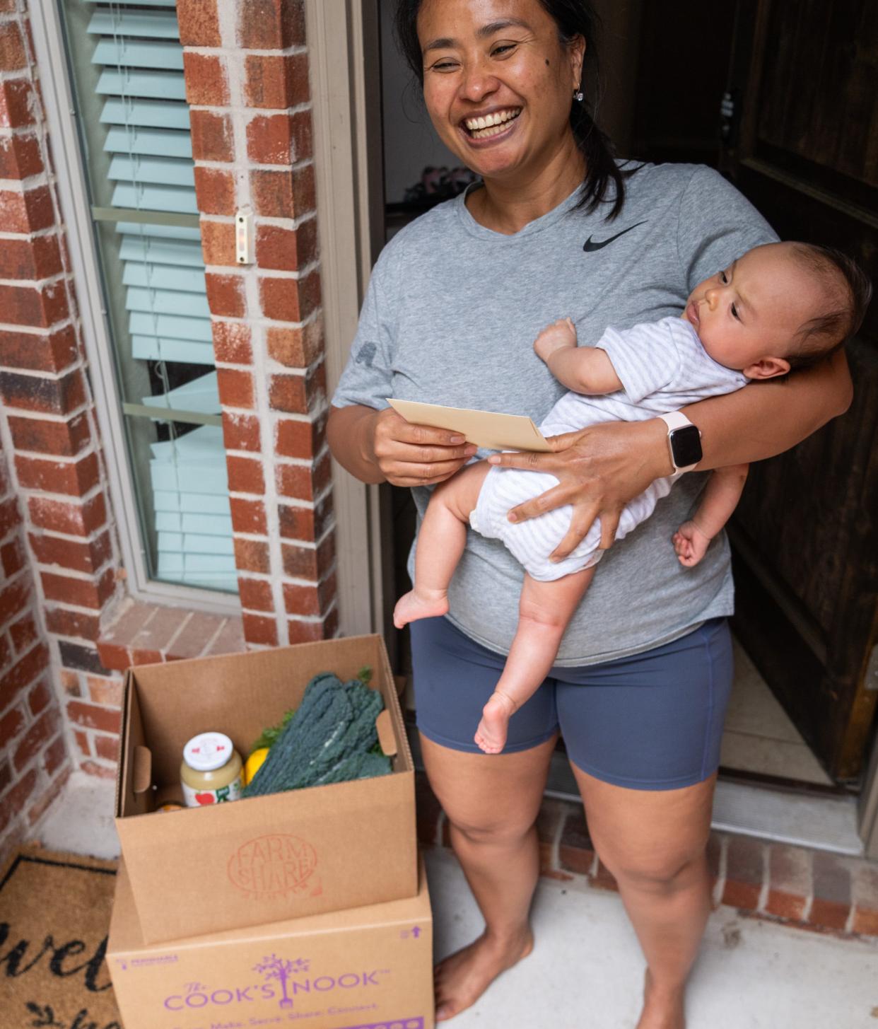 Inten Utari and her baby, Nadia, receive a delivery at their door from the Food is the Best Medicine program.
