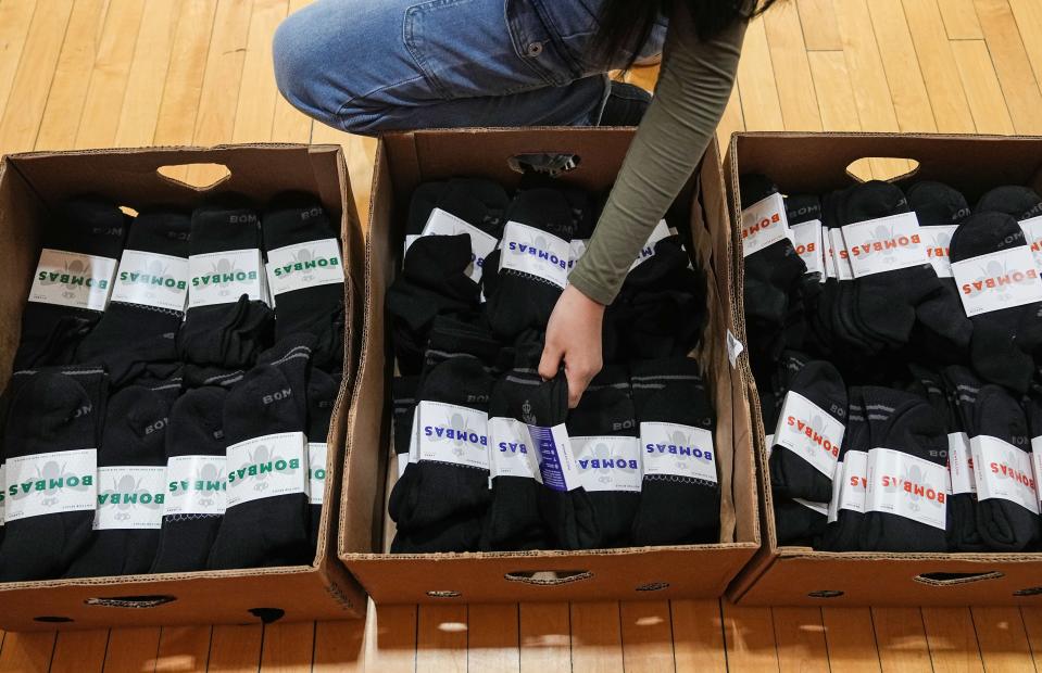 Indianapolis students pick out shirts, shoes and socks Tuesday, Aug. 29, 2023, during the Back to School Essential Giveaway to Empower Indianapolis Students at the JTV Hill Center in Indianapolis.