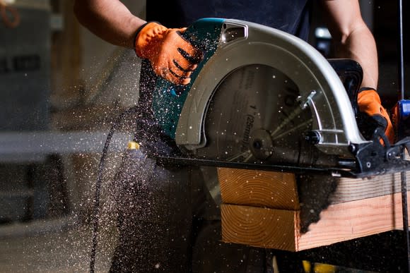 Man using large saw.