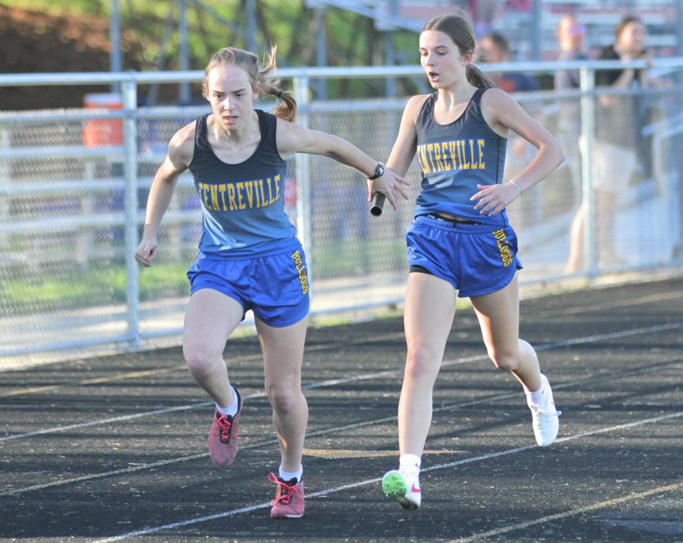 Leah Roberts hands off the baton to Ellie Miller in the 800 relay on Monday.