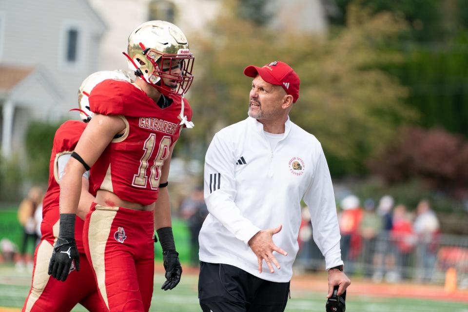 Head Coach Vito Camanille of Bergen Catholic talks to John Morris (18) of Bergen Catholic after a play during a football game between Bergen Catholic High School and St. Joseph Regional High School at Bergen Catholic High School in Oradell on Sunday, October 15, 2023.