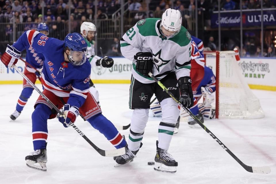 Feb 20, 2024; New York, New York, USA; New York Rangers defenseman Ryan Lindgren (55) fights for the puck against Dallas Stars left wing Jason Robertson (21) during the third period at Madison Square Garden. Mandatory Credit: Brad Penner-USA TODAY Sports