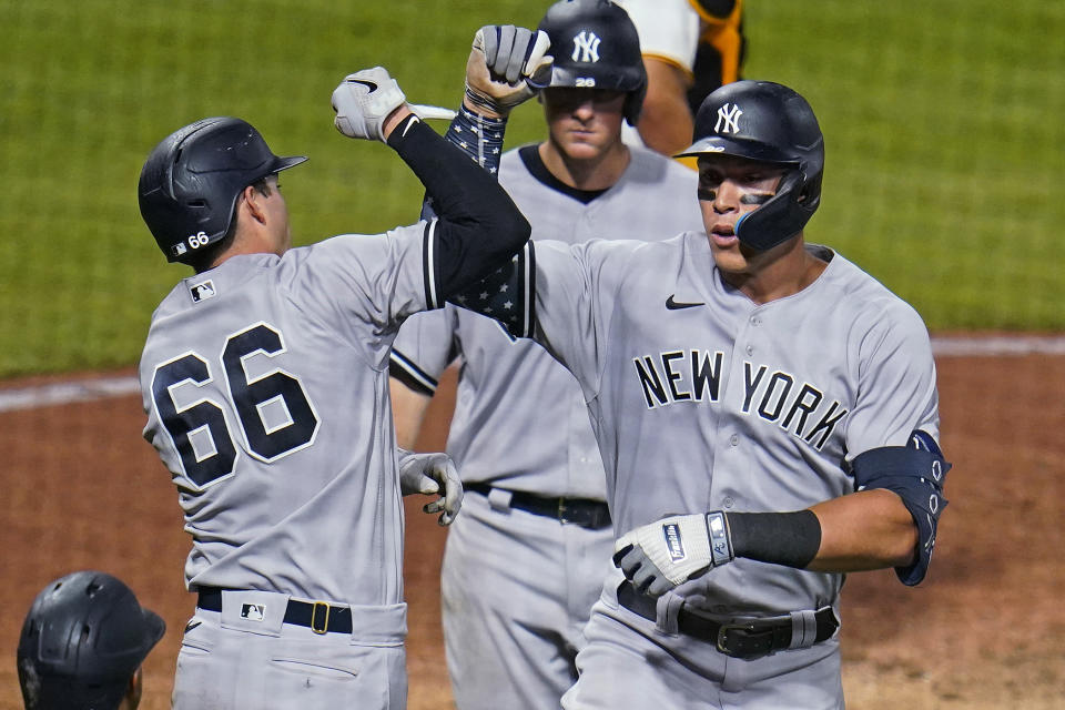 New York Yankees' Aaron Judge, right, celebrates with Kyle Higashioka (66) as he returns to the dugout after hitting a grand slam off Pittsburgh Pirates relief pitcher Manny Banurelos during the eighth inning of a baseball game in Pittsburgh, Wednesday, July 6, 2022. (AP Photo/Gene J. Puskar)