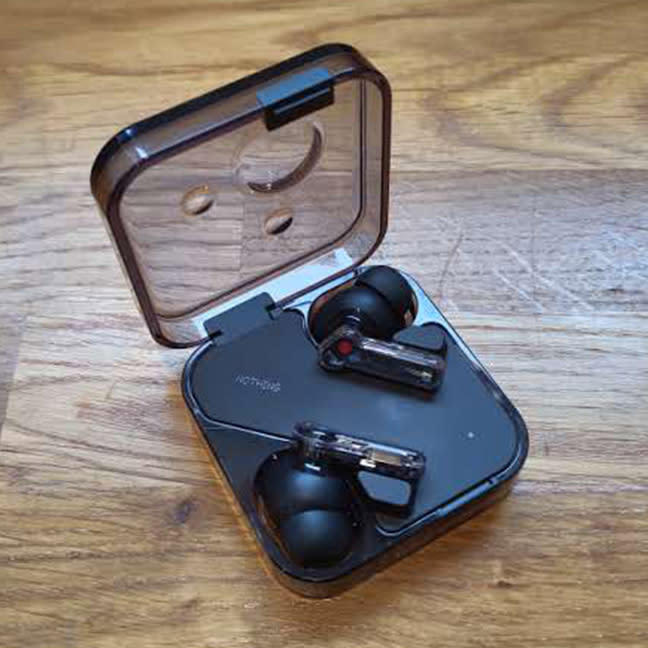 Nothing Ear review; black ear buds on a wooden table