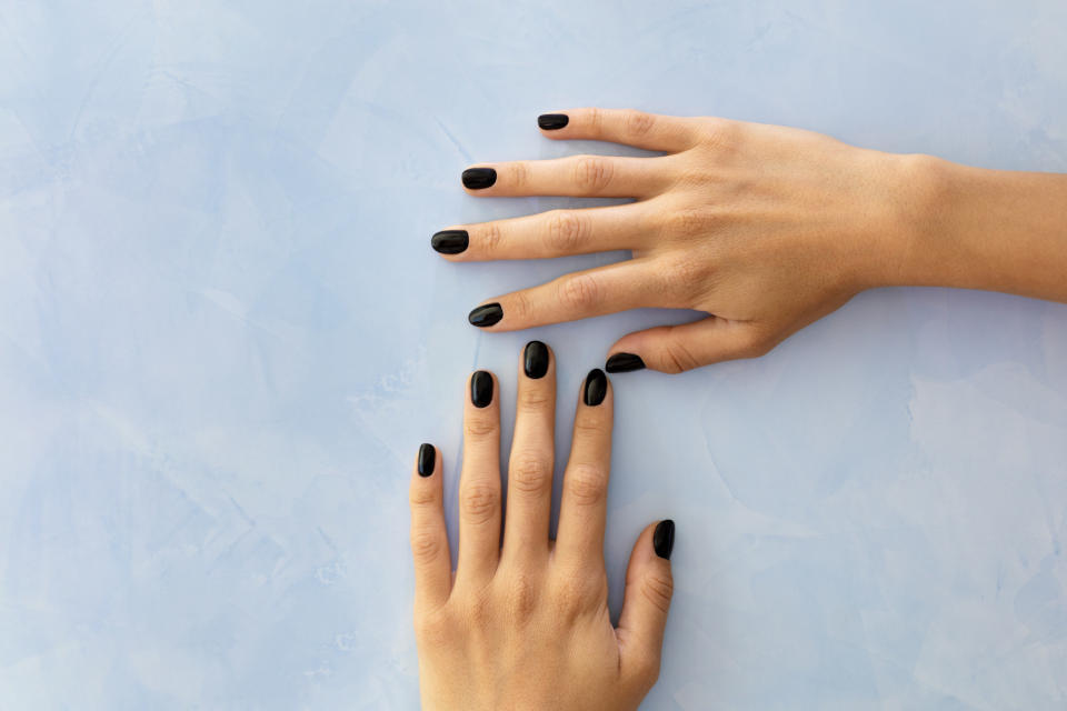 black nail polish on a person's hands