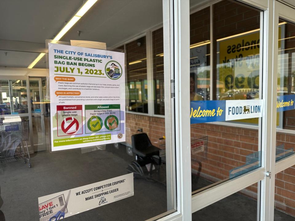 A notice on the door of Food Lion store on Snow Hill Road in Salisbury reminds shoppers that the city's single-use plastic bag ban begins July 1, 2023.