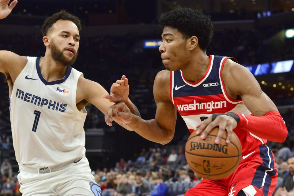 Washington Wizards forward Rui Hachimura handles the ball against Memphis Grizzlies forward Kyle Anderson (1) in the first half of an NBA basketball game Saturday, Dec. 14, 2019, in Memphis, Tenn. (AP Photo/Brandon Dill)